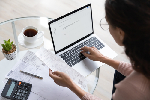 woman using a computer to pay bills