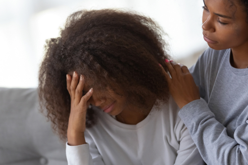 woman consoling her friend after going through the stages of trauma bonding