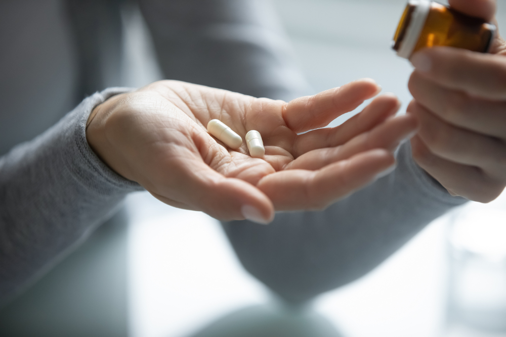 person taking two pills at once