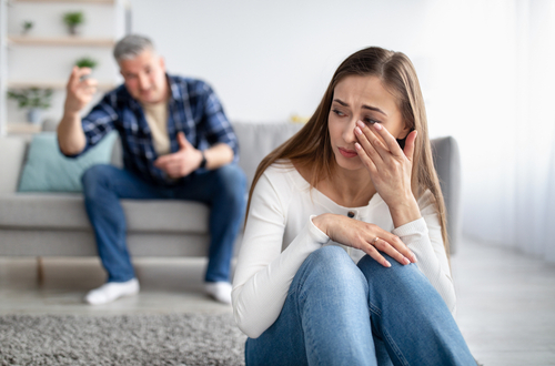 man yelling at woman while she cries