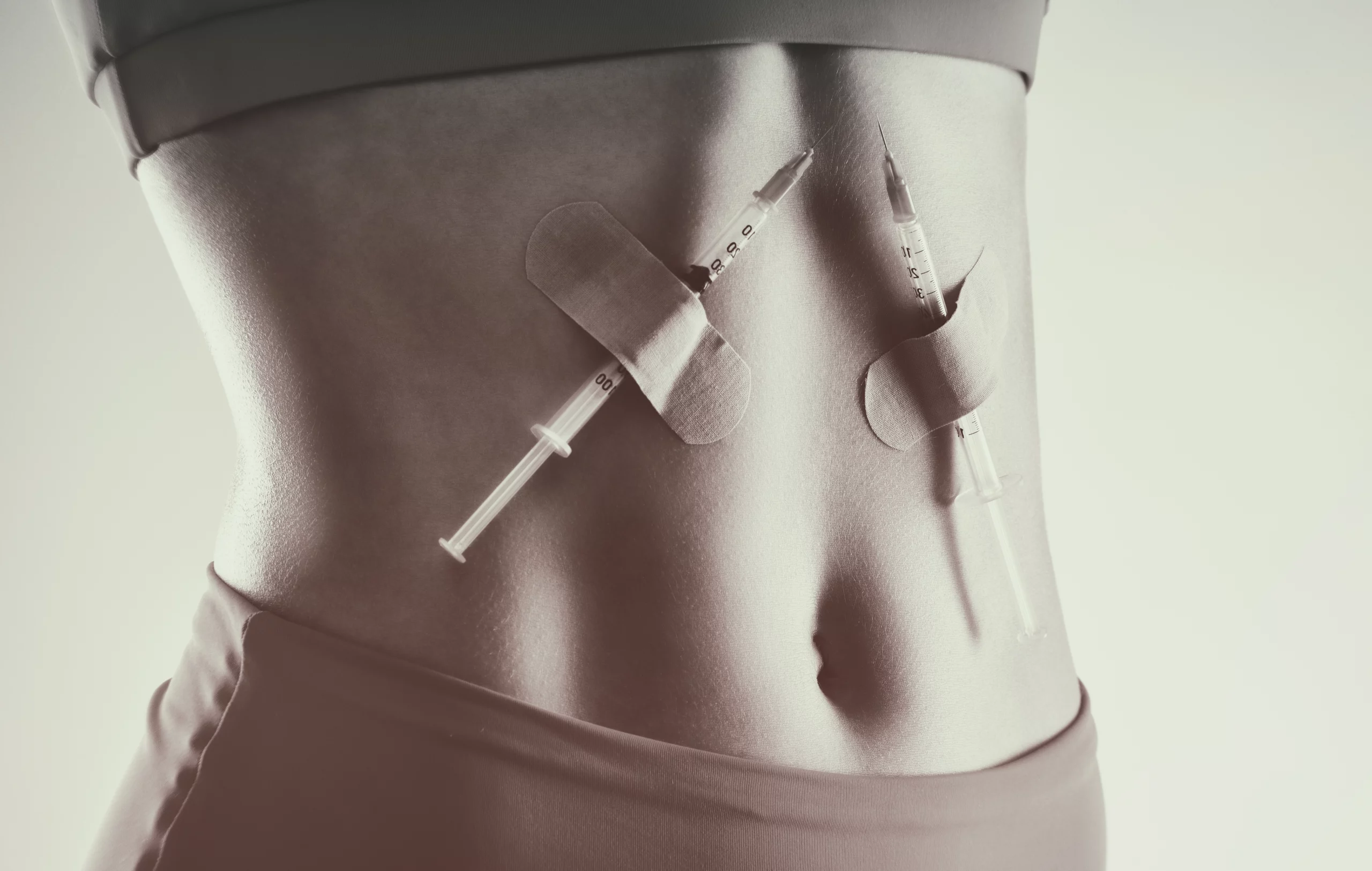 woman with syringes taped to her stomach