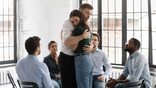 woman hugging a man during addiction recovery sessions