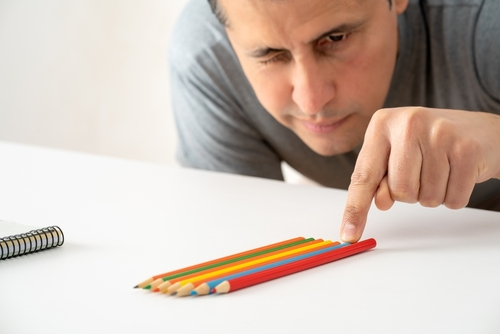 man adjusting pencils due to ocd