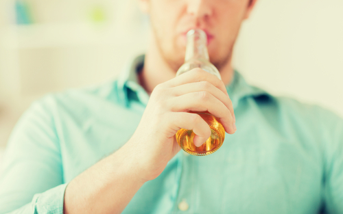 man drinking a non-alcoholic beer