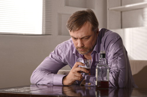 man sitting with alcohol